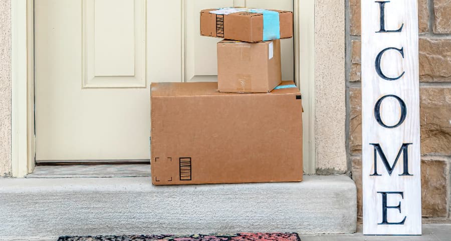 Boxes by the door of a residence with a welcome sign in Johnson City